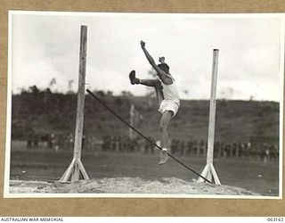 DONADABU, PAPUA, NEW GUINEA. 1944-01-01. PRIVATE SHERRINGTON FAILS TO CLEAR THE BAR IN THE HIGH JUMP EVENT AT THE 15TH INFANTRY BRIGADE GYMKHANA