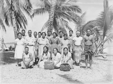 [Group portrait of Polynesian people standing outside]