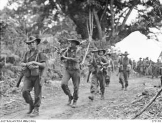 TSIMBA AREA, BOUGAINVILLE ISLAND. 1945-02-21. TROOPS OF B COMPANY, 26TH INFANTRY BATTALION MOVING FROM PUTO BEACH TOWARDS THE AREA OCCUPIED BY THE 31/51ST INFANTRY BATTALION WHERE THEY ARE TO TAKE ..