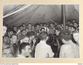 TOROKINA, BOUGAINVILLE. 1945-04-16. BOB DYER (1), AND WILLA HOKIN (2), ENTERTAINING PATIENTS AT THE 2/1 GENERAL HOSPITAL DURING THE VISIT OF THE BOB DYER CONCERT PARTY