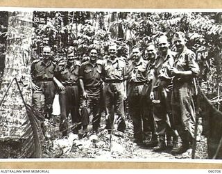 FINSCHHAFEN, NEW GUINEA. 1943-10-30. OFFICERS OF HEADQUARTERS, 26TH AUSTRALIAN INFANTRY BRIGADE. THEY ARE LEFT TO RIGHT: NX12355 CAPTAIN B. STANILANDS; VX36046 CAPTAIN T. H. MATTHEWS; NX12365 MAJOR ..