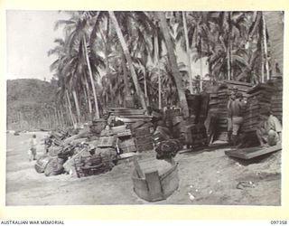 BUIN AREA, BOUGAINVILLE. 1945-09-28. PERSONAL STORES AND EQUIPMENT ON THE BEACH NEAR THE JAPANESE NAVAL HEADQUARTERS AWAITING TRANSPORT TO FAURO ISLAND WHERE JAPANESE TROOPS FROM THE BUIN AREA ARE ..