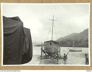 KWIARA, CHINA STRAITS, 1943-07-06. THE 016-2 IS SLIPPED BACK INTO THE WATER AFTER REPAIRS AT THE 1ST AUSTRALIAN WATER TRANSPORT GROUP MAINTENANCE BASE