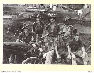 SORAKEN, BOUGAINVILLE. 1945-06-02. THE CREW OF NO. 3 GUN, 2 MOUNTAIN BATTERY AND THEIR GUN. IDENTIFIED PERSONNEL ARE:- BOMBARDIER E.R. PINKERTON (1); GUNNER A.J. MARSHALL (2); GUNNER J.A. MARSHALL ..