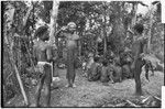 Distribution of wild pig meat: Tomegai and Kwibigai clans feast on pork, man playfully salutes