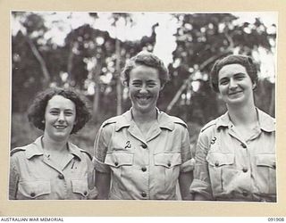 LAE, NEW GUINEA, 1945-05-18. PERSONNEL FROM AUSTRALIAN WOMEN'S ARMY SERVICE BARRACKS STANDING NEAR A FORMER COMMANDO CAMP ON THE BANKS OF THE BUSU RIVER. THEY ARE PARTICIPATING IN A TOUR OF THE ..