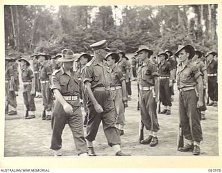 TOROKINA, BOUGAINVILLE, SOLOMON ISLANDS. 1944-12-15. MAJOR GENERAL W. BRIDGEFORD, GENERAL OFFICER COMMANDING 3 DIVISION, (2), ACCOMPANIED BY LIEUTENANT COLONEL N.L. GOBLE, (1), INSPECTS ..