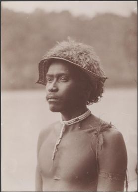 A young man of Vella Lavella wearing sunshade, Solomon Islands, 1906 / J.W. Beattie