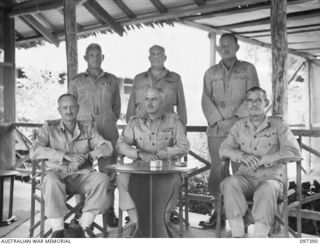 LAE, NEW GUINEA. 1945-10-04. MEMBERS OF HEADQUARTERS FIRST ARMY IN ANTEROOM 'A' MESS. IDENTIFIED PERSONNEL ARE:- BRIGADIER E.L. SHEEHAN, BRIGADIER, GENERAL STAFF (1); BRIGADIER R.H. NIMMO, DEPUTY ..