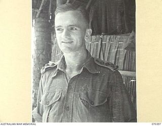 MILNE BAY, NEW GUINEA, 1944-02-12. NX127352 CAPTAIN G.A. COLMAN , GENERAL STAFF OFFICER III, PICTURED AT HEADQUARTERS MILNE BAY BASE SUB AREA