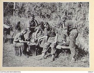 BUT, NEW GUINEA. 1945-04-10. C COMPANY, 2/8 INFANTRY BATTALION OFFICERS PLAYING CHESS AT THEIR CAMP. IDENTIFIED PERSONNEL ARE:- LT W.H. WESTWOOD (1); CAPT E.L. WATSON (2); CAPT M.J. DWYER (3); LT ..