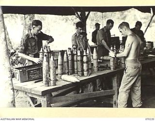 PORT MORESBY, NEW GUINEA. 1944-02-02. VX119949 PRIVATE H. DARCY (1) REPAIRING A 25 POUNDER HIGH EXPLOSIVE SHELL AT THE 6TH MOBILE AMMUNITION REPAIR SHOP IN THE 8TH ADVANCED AMMUNITION DEPOT. ..