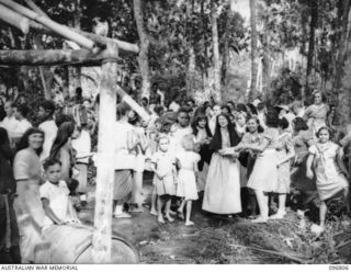 Ramale Mission, Kokopo Area, New Britain. The farewell scene as ten of a group of 300 white former internees leave Ramale Mission for evacuation to Rabaul to receive medical treatment at 4 Field ..