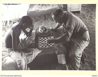 BORAM BEACH, NEW GUINEA. 1945-10-17. SEPOY CHAIN SINGH, 2/12TH F.F. REGIMENT (1), AN INDIAN SOLDIER LIBERATED IN THE SEPIK RIVER AREA AND BROUGHT TO WEWAK FOR TREATMENT, PLAYING DRAUGHTS WITH ..