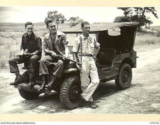 KELANOA, NEW GUINEA, 1944-03-04. PICTURED ALONGSIDE A JEEP ARE CORPORAL GORDON S. BRADLEY, OF MASSACHUSETTS (1); CORPORAL VALLE F. O'DONNELL, OF OHIO (2); AND LIEUTENANT W.W. DIBBLE, OF COLUMBIA, ..