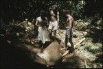 Men making petroglyph carvings