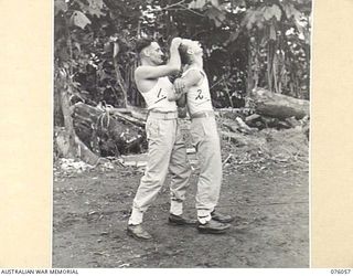 LAE, NEW GUINEA. 1944-09-21. SERGEANT A.J. DENSMORE (1) AND CORPORAL J.L. LEYS (2) OF THE NEW GUINEA FORCE PROVOST COMPANY PRACTICING UNARMED COMBAT