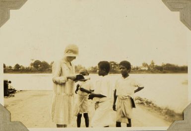 Fijian schoolboys showing Ethel Vickery their school books, 1928