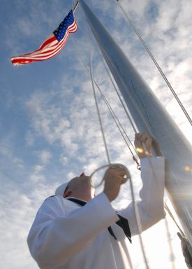 060807-N-9662L-021 (Aug. 7, 2006)US Navy (USN) SEAMAN Todd Lassiter raises the National ENSIGN during Morning Colors at Commander, Naval Forces Marianas, located at Santa Rita, Guam. SEAMAN Lassiter is assigned to Naval Facilities Engineering Command Marianas as a Postal Clerk. U.S. Navy photo by Mass Communication SPECIALIST Second Class John F. Looney (RELEASED)