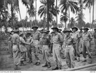 AITAPE, NEW GUINEA. 1945-03-20. GENERAL SIR THOMAS A. BLAMEY, COMMANDER-IN-CHIEF, ALLIED LAND FORCES, SOUTH WEST PACIFIC AREA (1), SHAKING HANDS WITH LIEUTENANT W.E. COX, SIGNAL SECTION 2/1 FIELD ..