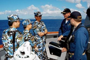 U.S Navy Sailors from the Arleigh Burke Class Guided Missile Destroyer USS CHUNG-HOON (DDG 93) talks to Chinese Peoples Liberation Army Navy Sailors from the Luhu (Type 052) Class Guided Missile Destroyer QINGDAO (DDG 113) during a Communications and Passing Exercise at Naval Station Pearl Harbor, Hawaii, on Sept. 10, 2006. (U.S. Navy photo by Mass Communication SPECIALIST 3rd Class Ben A. Gonzales) (Released)