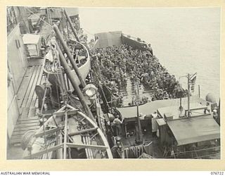 TOROKINA, SOLOMON ISLANDS, 1944-11-01. TROOPS OF THE 3RD DIVISION HEADQUARTERS GOING OVER THE SIDE OF THE LIBERTY SHIP, LINDLEY M. GARRISON INTO AMERICAN LCIS (LANDING CRAFT INFANTRY) FOR TRANSPORT ..