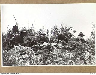 SATTELBERG AREA, NEW GUINEA. 1943-11-17. TROOPS OF THE 2/48TH. AUSTRALIAN INFANTRY BATTALION LEAVING A SHELL HOLE TO ATTACK A JAPANESE PILLBOX. SHOWN ARE: SX7699 PRIVATE C. S. FRASER (1.) SX11257 ..