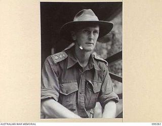 BITAGALIP, NEW BRITAIN, 1945-12-01. CAPTAIN S.J.B. ASPREY, INVESTIGATING OFFICER, LEGAL SECTION, HQ 11 DIVISION, WHO IS DEALING WITH THE IDENTIFICATION OF JAPANESE WAR CRIMINALS AROUND RABAUL