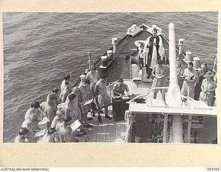 TOROKINA, BOUGAINVILLE, 1945-07-08. THE NAVY CHURCH SERVICE ON BOARD THE CORVETTE, HMAS KIAMA, BEING CONDUCTED BY CHAPLAIN F.O. HULME-MOIR, HEADQUARTERS 2 CORPS (1). PERSONNEL FROM HMAS LITHGOW AND ..