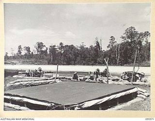 JACQUINOT BAY, NEW BRITAIN, 1945-08-31. THE BATTERY COMMAND POST OF 141 HEAVY ANTI-AIRCRAFT BATTERY ROYAL AUSTRALIAN ARTILLERY AT WORK ON THEIR INSTRUMENTS