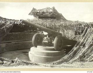 PORT MORESBY, NEW GUINEA. 1944-04-15. THE NO. 2 GUN, 155MM M1917 HEAVY ARTILLERY POSITIONED AT A GUN PIT OF THE BOERA HEAVY BATTERY, WITH THE CONTROL TOWER AT THE REAR. THE GUN PIT WAS CONSTRUCTED ..