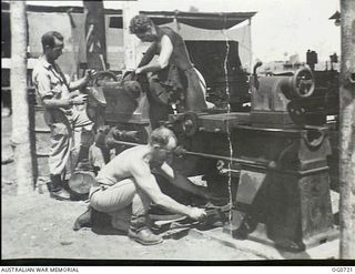 NADZAB, NEW GUINEA. C. 1944-02. THIS JAPANESE LATHE, SALVAGED FROM A WRECKED SHIP AT SALAMAUA IS NOW BEING USED BY NO. 62 MOBILE WORKS SQUADRON RAAF IN NG TO REPAIR BULLDOZER AND OTHER EQUIPMENT ..