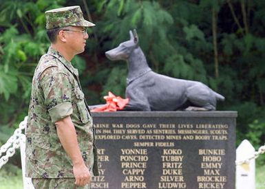 Lieutenant Colonel Nakatsu Kiyotoshi, and Lieutenant Colonel Tadashi Hattori, of the Japanese Army, stand at the memorial of the war dogs on the Guam Navel Base during Exercise KOA THUNDER 2001. KOA THUNDER is an exercise involving elements of 1ST Marine Air Wing (MAW), and 3rd Marine Division, where Marines conduct an Operational Readiness Exercise (ORE). The Aviation Support Element (ASE) from Kaneohe Bay, Hawaii, will be tested on command and control of several different missions, to include Tactical Recovery of Aircraft and Personal (TRAP), airfield seizures, and a Noncombatant Evacuation Operation (NEO)