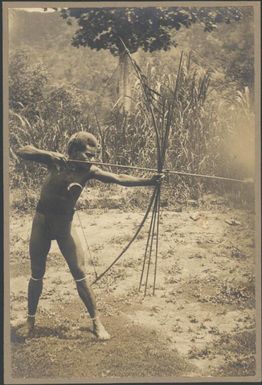 Manau from Aitape, the Chinnery's house boy firing a bow and arrow, Rabaul, New Guinea, ca. 1935 / Sarah Chinnery