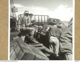 LAE, NEW GUINEA. 1944-06-14/02. UNLOADING RATIONS FROM A LANDING BARGE OF THE 12TH WATER TRANSPORT OPERATING COMPANY