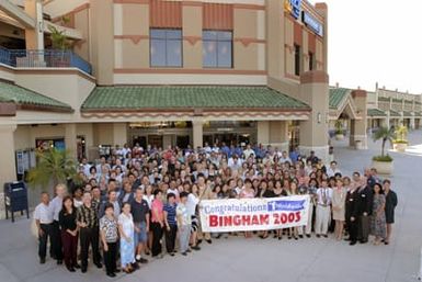 Employees gather in front of the Pearl Harbor Navy Exchange (NEX) with Commander, Navy Region Hawaii/Commander, Naval Surface Group, Middle Pacific, US Navy (USN) Captain (CAPT) Ronald R. Cox (left at sign), for a group photo after receiving the 2003 Bingham Award. The Pearl Harbor NEX received the Bingham award for having more than $209 million in sales and excellence in customer service and employee satisfaction for 2003. The Bingham Award named after the late USN CAPT W.H. Bingham, who in 1946 was directed by the Secretary of the Navy (SECNAV) to establish the NEX system