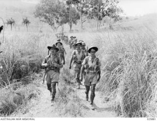 PORT MORESBY, PAPUA 1942-07-11. AUSTRALIAN INFANTRY MARCHING ALONG BUSH TRACKS AS THEY MOVE UP TO "ATTACK" DURING MANOEUVERES CARRIED OUT UNDER THE DIRECTION OF A.I.F. COMMANDER FROM THE MIDDLE ..