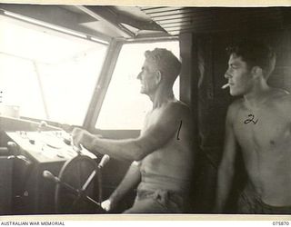 ALEXISHAFEN NORTH, POTSDAM AREA, NEW GUINEA. 1944-09-02. NX190560 SERGEANT W. BUDDLE, SKIPPER (1) AND VX110540 SAPPER A. BUSHBY, MATE (2) IN THE CABIN OF THE MEDICAL LAUNCH, AM1568 OF THE 4TH SEA ..