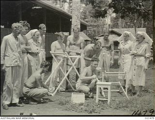 MILNE BAY, PAPUA. C. 1944-02. RAAF NURSING SISTERS WITH PATIENTS, SOME PAINTING WOODEN FURNITURE, OUTSIDE A HOSPITAL WARD AT NO. 2 MEDICAL CLEARING STATION RAAF