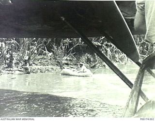 NEW GUINEA, 1942-1943. POSSIBLY WAIROPE RIVER - PROBABLY A NAVY COASTWATCHER GOING ASHORE WITH HIS EQUIPMENT FROM A CATALINA. (2 OF 5)