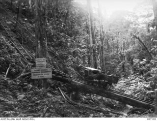 BOUGAINVILLE. 1945-09-26. A JEEP COMES DOWN FROM THE NUMA NUMA TRAIL ON A TRAMWAY CONSTRUCTED BY ENGINEERS OF 23 FIELD COMPANY ROYAL AUSTRALIAN ENGINEERS