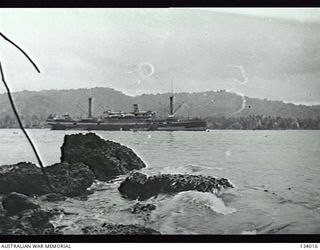 FINSCHHAFEN, NEW GUINEA. 1944-02. TROOPSHIP PREPARING TO DEPART WITH AUSTRALIAN TROOPS ON BOARD RETURNING HOME ON LEAVE