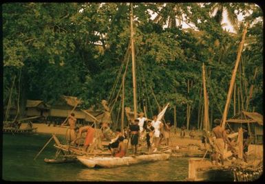 Native Affairs Patrol leaving Mapamoiwa village (a yellow filter left on the lens in slide 470) : Mapamoiwa village, D'Entrecasteaux Islands, Papua New Guinea, 1956 / Terence and Margaret Spencer
