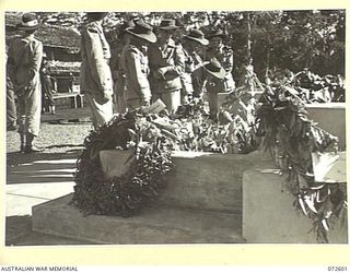 LAE, NEW GUINEA. 1944-04-23. MEMBERS OF THE AUSTRALIAN ARMY NURSING SERVICE FROM THE 2/7TH GENERAL HOSPITAL INSPECTING WREATHS LAID DURING THE DEDICATION SERVICE AT LAE WAR CEMETERY. THE DEDICATION ..
