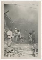 Litter Bearers in Front of Destroyed Motor Torpedo Squadron 3 Warehouse