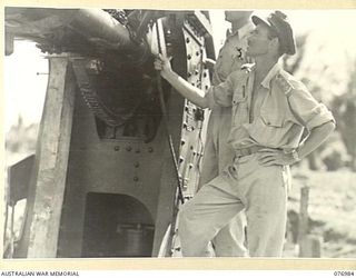 JACQUINOT BAY, NEW BRITAIN. 1944-11-17. VX104108 CAPTAIN J.S. MCCALLUM, COMMANDING OFFICER (1) AND NX70914 CAPTAIN J.S. KESSELL, GENERAL STAFF OFFICER III, 5TH BASE SUB AREA (2) INSPECTING ONE OF ..