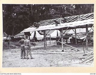 BOUGAINVILLE, 1945-06-18. NATIVES WORKING ON ADDITIONAL BUILDING TO 109 CASUALTY CLEARING STATION, MOTUPENA POINT