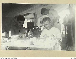 ALEXISHAFEN, NEW GUINEA, 1944-05-11. MEMBERS OF C SECTION, 2/5TH DENTAL UNIT AT WORK IN THEIR TENT COVERED DENTAL LABORATORY. IDENTIFIED PERSONNEL ARE:- VX85609 CORPORAL R.J. MERTON (1); WX8044 ..