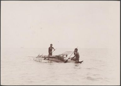 Two men in a canoe off the coast of Vanikolo, Santa Cruz Islands, 1906 / J.W. Beattie