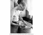 Kelshaw Bonham dissecting clam tissue at the Eniwetok Marine Biological Laboratory, summer 1964